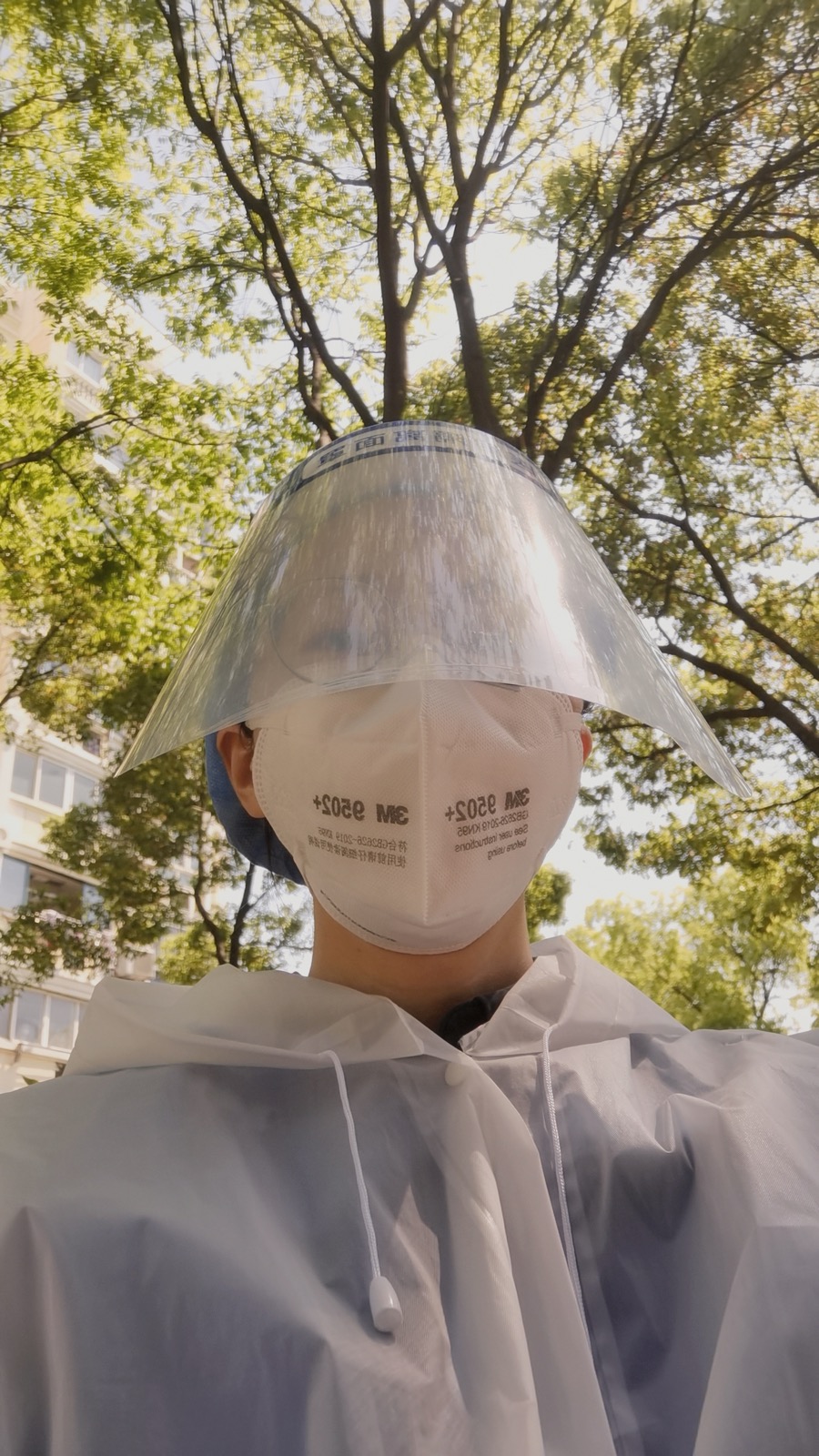 Fully geared up in PPE — face shield, N95 mask, protective suit — during COVID lockdown