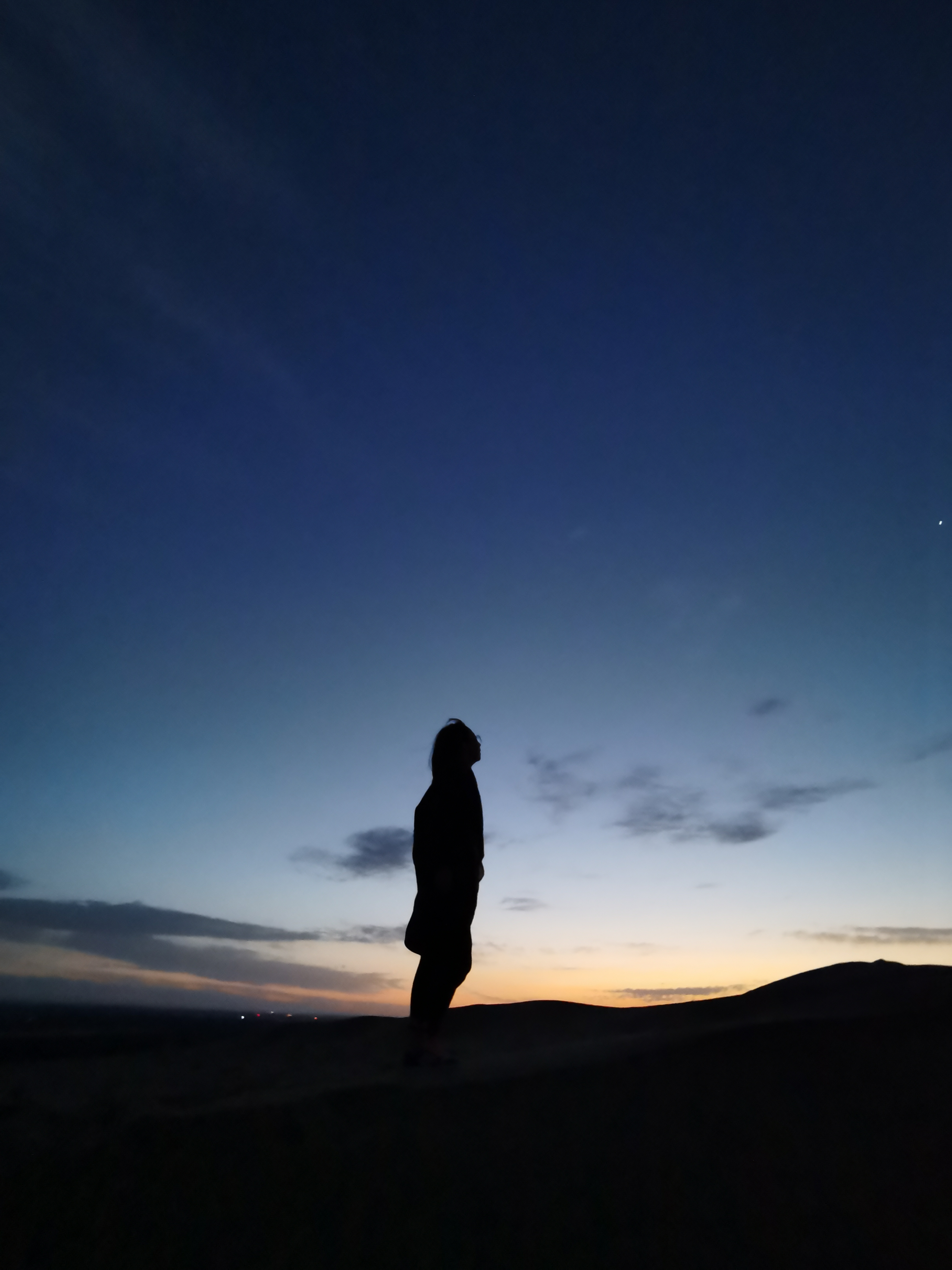 Silhouette on Dunhuang sand dune at dusk