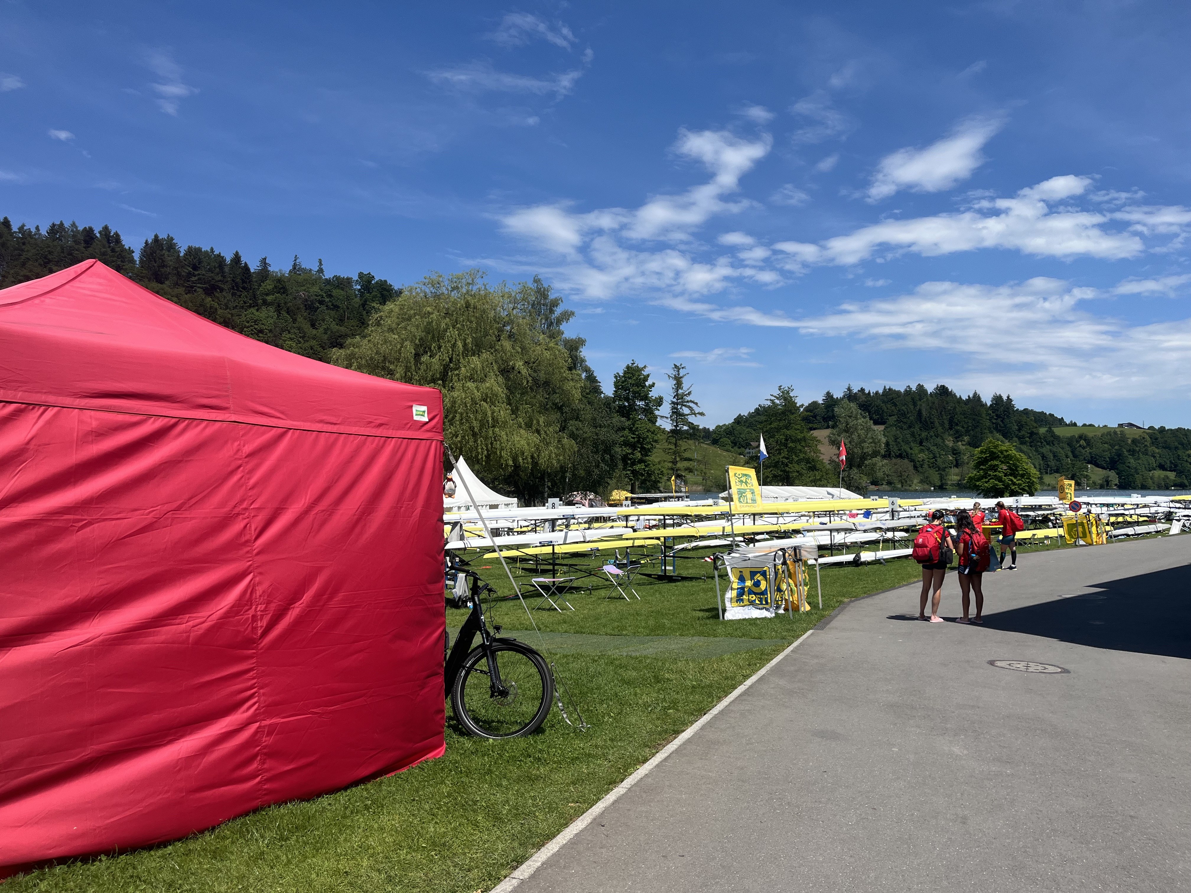 Rotsee venue, red tent and boat racks in the sun